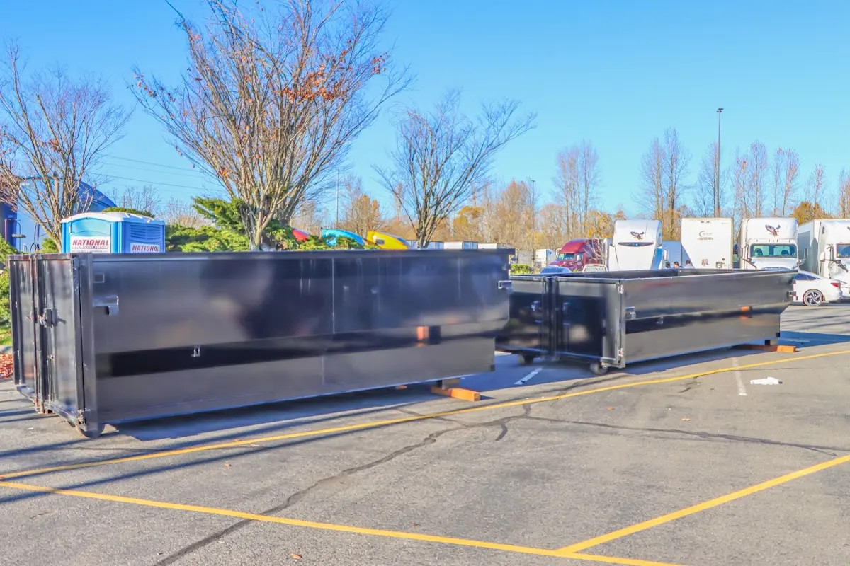 Professional dumpster rental service with roll-off container on residential driveway in Felida